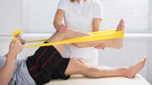 Learn more about the Sydney DPT physiotherapist with patient using exercise band