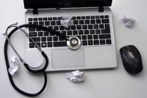 Questions about admissions? Book a chat! laptop with stethoscope