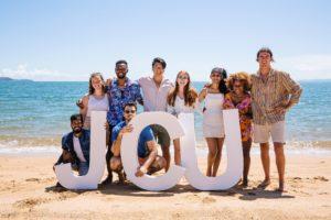 Find out if James Cook University is the uni for you! james cook university students on the beach with sign