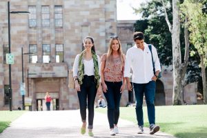 Learn more about studying at UQ university of queensland students walking on campus