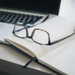 laptop book and glasses