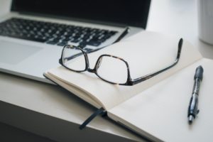 laptop book and glasses
