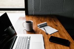 Learn more about studying law at an Australian university laptop, notepad, and coffee