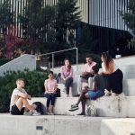 students sitting on steps on deakin university burwood campus