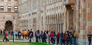 students walking by the UQ Great Court