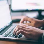 hands working on laptop