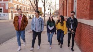 university students walking on sidewalk