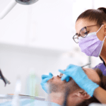 young female dentist working with patient