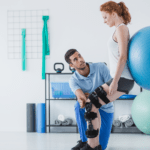 physiotherapist working with patient with ball
