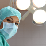doctor wearing scrubs and mask in operating room